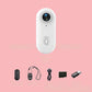 4K Thumb Camera – Ultra Compact with accessories including a remote and USB cable on a pink background.