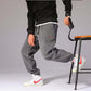 Mens Casual Pants with a relaxed fit, paired with a black sweater and stylish sneakers, perfect for casual outings.