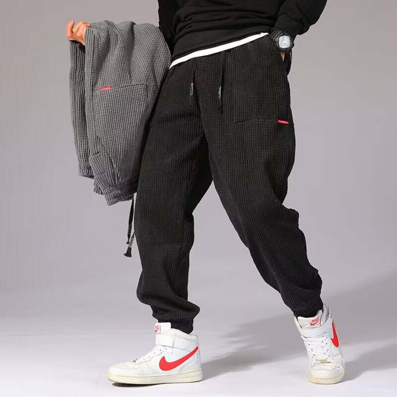 Mens Casual Pants with stylish pockets and comfortable fit, showcased with matching jacket and sporty sneakers.