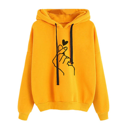 Fleece Hoodie in yellow with heart print design and stylish hand gesture on front.