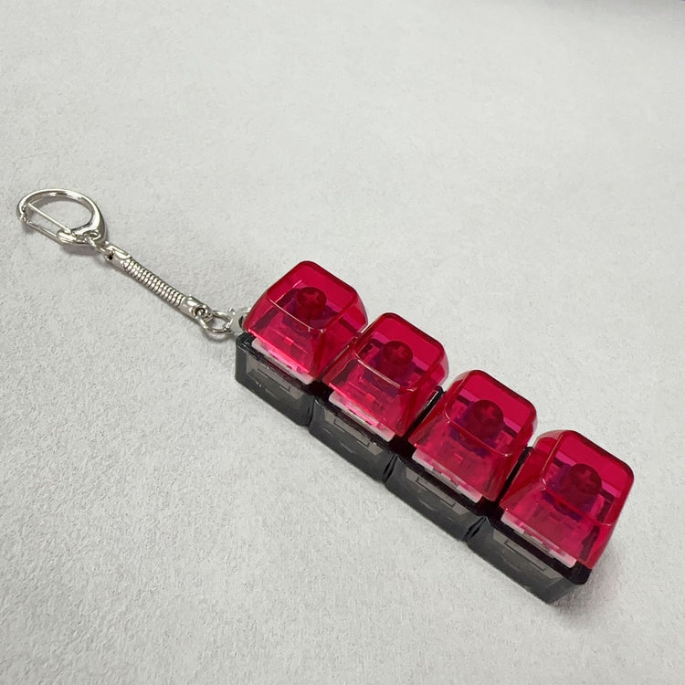 Clickie Keychain with vibrant red tops and black base, perfect for organizing keys stylishly.