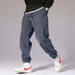 Mens Casual Pants in a relaxed fit, featuring pockets and styled with white sneakers.