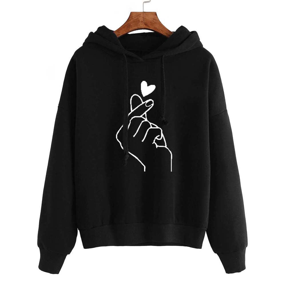 Fleece Hoodie with heart print design on black background, featuring stylish hand gesture.