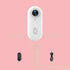 4K Thumb Camera – Ultra Compact in white with accessories on a pink background