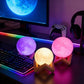 Rechargeable Moon Night Light with Touch Control on a desk with a colorful LED setup.