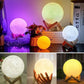 Rechargeable Moon Night Light with Touch Control in various colors and sizes displayed on wooden stands.