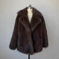 Fluffy Fox Fur Coat Women Loose Elegant Winter displayed on a mannequin, showcasing its luxurious design in a soft brown hue.